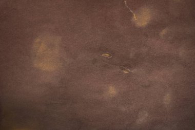 Aged paper sheet. Blank old background with dust and dirty stains. Vintage and antique art concept. Poster mockup. Detailed closeup studio shot. Front view. Toned