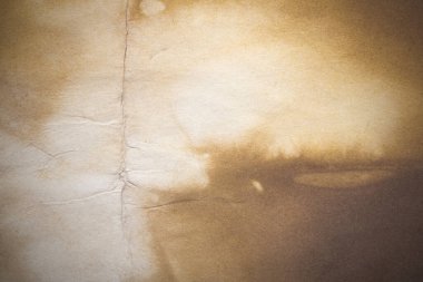 Aged paper sheet. Blank old background with dust and dirty stains. Vintage and antique art concept. Poster mockup. Detailed closeup studio shot. Front view. Toned