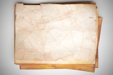 Aged paper sheet. Blank old background with dust and dirty stains. Vintage and antique art concept. Poster mockup. Detailed closeup studio shot. Front view. Toned