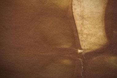 Aged paper sheet. Blank old background with dust and dirty stains. Vintage and antique art concept. Poster mockup. Detailed closeup studio shot. Front view. Toned