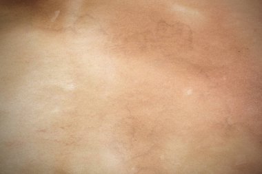 Aged paper sheet. Blank old background with dust and dirty stains. Vintage and antique art concept. Poster mockup. Detailed closeup studio shot. Front view. Toned