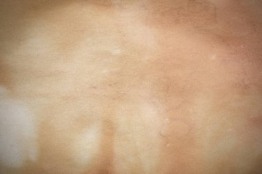 Aged paper sheet. Blank old background with dust and dirty stains. Vintage and antique art concept. Poster mockup. Detailed closeup studio shot. Front view. Toned