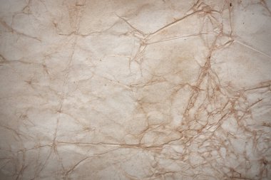 Aged paper sheet. Blank old background with dust and dirty stains. Vintage and antique art concept. Poster mockup. Detailed closeup studio shot. Front view. Toned