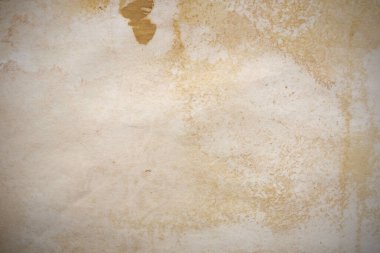 Aged paper sheet. Blank old background with dust and dirty stains. Vintage and antique art concept. Poster mockup. Detailed closeup studio shot. Front view. Toned