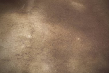 Aged paper sheet. Blank old background with dust and dirty stains. Vintage and antique art concept. Poster mockup. Detailed closeup studio shot. Front view. Toned
