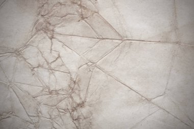 Aged paper sheet. Blank old background with dust and dirty stains. Vintage and antique art concept. Poster mockup. Detailed closeup studio shot. Front view. Toned