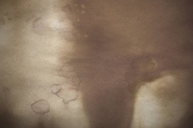 Aged paper sheet. Blank old background with dust and dirty stains. Vintage and antique art concept. Poster mockup. Detailed closeup studio shot. Front view. Toned