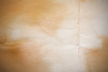 Aged paper sheet. Blank old background with dust and dirty stains. Vintage and antique art concept. Poster mockup. Detailed closeup studio shot. Front view. Toned