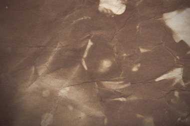 Aged paper sheet. Blank old background with dust and dirty stains. Vintage and antique art concept. Poster mockup. Detailed closeup studio shot. Front view. Toned