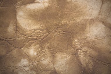 Aged paper sheet. Blank old background with dust and dirty stains. Vintage and antique art concept. Poster mockup. Detailed closeup studio shot. Front view. Toned