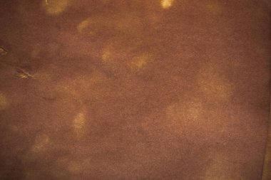 Aged paper sheet. Blank old background with dust and dirty stains. Vintage and antique art concept. Poster mockup. Detailed closeup studio shot. Front view. Toned