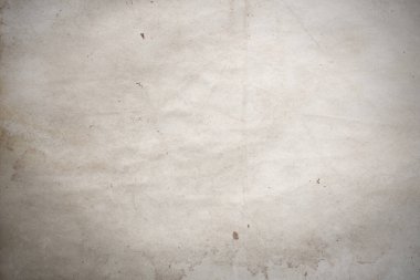 Aged paper sheet. Blank old background with dust and dirty stains. Vintage and antique art concept. Poster mockup. Detailed closeup studio shot. Front view. Toned