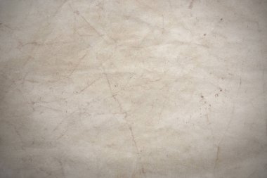 Aged paper sheet. Blank old background with dust and dirty stains. Vintage and antique art concept. Poster mockup. Detailed closeup studio shot. Front view. Toned