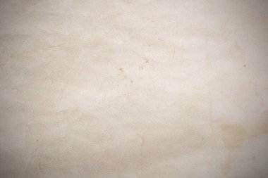 Aged paper sheet. Blank old background with dust and dirty stains. Vintage and antique art concept. Poster mockup. Detailed closeup studio shot. Front view. Toned