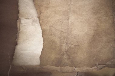 Aged paper sheet. Blank old background with dust and dirty stains. Vintage and antique art concept. Poster mockup. Detailed closeup studio shot. Front view. Toned