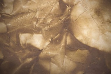 Aged paper sheet. Blank old background with dust and dirty stains. Vintage and antique art concept. Poster mockup. Detailed closeup studio shot. Front view. Toned