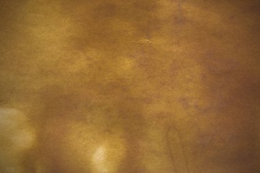 Aged paper sheet. Blank old background with dust and dirty stains. Vintage and antique art concept. Poster mockup. Detailed closeup studio shot. Front view. Toned