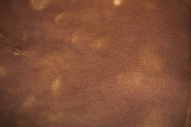 Aged paper sheet. Blank old background with dust and dirty stains. Vintage and antique art concept. Poster mockup. Detailed closeup studio shot. Front view. Toned