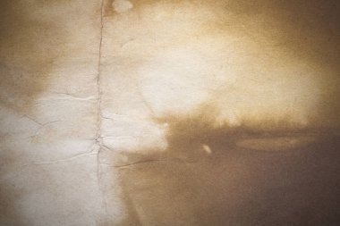 Aged paper sheet. Blank old background with dust and dirty stains. Vintage and antique art concept. Poster mockup. Detailed closeup studio shot. Front view. Toned