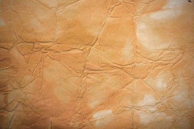 Aged paper sheet. Blank old background with dust and dirty stains. Vintage and antique art concept. Poster mockup. Detailed closeup studio shot. Front view. Toned