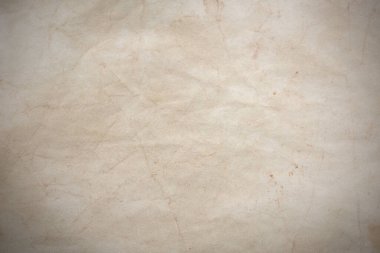 Aged paper sheet. Blank old background with dust and dirty stains. Vintage and antique art concept. Poster mockup. Detailed closeup studio shot. Front view. Toned