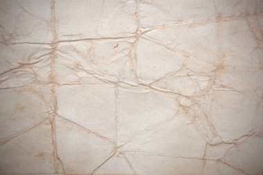 Aged paper sheet. Blank old background with dust and dirty stains. Vintage and antique art concept. Poster mockup. Detailed closeup studio shot. Front view. Toned