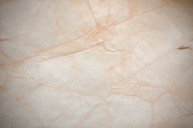 Aged paper sheet. Blank old background with dust and dirty stains. Vintage and antique art concept. Poster mockup. Detailed closeup studio shot. Front view. Toned