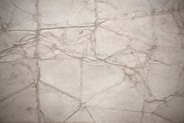 Aged paper sheet. Blank old background with dust and dirty stains. Vintage and antique art concept. Poster mockup. Detailed closeup studio shot. Front view. Toned