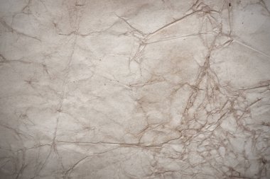 Aged paper sheet. Blank old background with dust and dirty stains. Vintage and antique art concept. Poster mockup. Detailed closeup studio shot. Front view. Toned