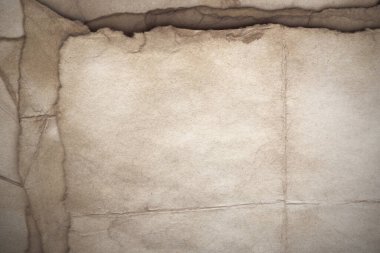Aged paper sheet. Blank old background with dust and dirty stains. Vintage and antique art concept. Poster mockup. Detailed closeup studio shot. Front view. Toned
