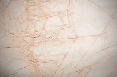 Aged paper sheet. Blank old background with dust and dirty stains. Vintage and antique art concept. Poster mockup. Detailed closeup studio shot. Front view. Toned