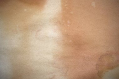 Aged paper sheet. Blank old background with dust and dirty stains. Vintage and antique art concept. Poster mockup. Detailed closeup studio shot. Front view. Toned