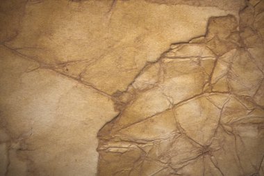 Aged paper sheet. Blank old background with dust and dirty stains. Vintage and antique art concept. Poster mockup. Detailed closeup studio shot. Front view. Toned