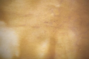 Aged paper sheet. Blank old background with dust and dirty stains. Vintage and antique art concept. Poster mockup. Detailed closeup studio shot. Front view. Toned