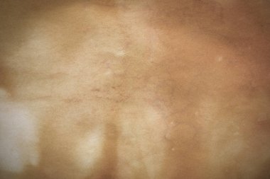 Aged paper sheet. Blank old background with dust and dirty stains. Vintage and antique art concept. Poster mockup. Detailed closeup studio shot. Front view. Toned