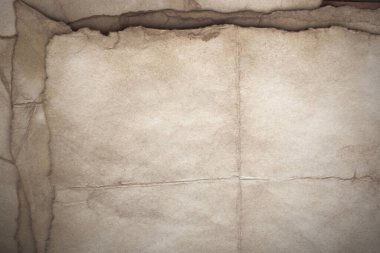 Aged paper sheet. Blank old background with dust and dirty stains. Vintage and antique art concept. Poster mockup. Detailed closeup studio shot. Front view. Toned