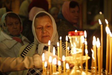 Belarus, Gomel city, celebrating the church holiday of Easter in St. Nicholas Monastery 01.05. 2016 year. Believing woman. Woman in the church clipart