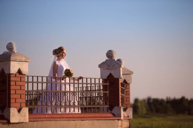 Belarus, Brest region, Motol village, August 05, 2017. Wedding park.Beautiful bride with a bouquet of flowers on a walk