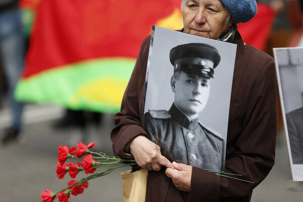 Belarus, Gomel, May 9, 2017, the Victory Day celebration.A woman carries a photograph of a father's soldier who died during the war.Loss of a loved one. The death of a soldier.