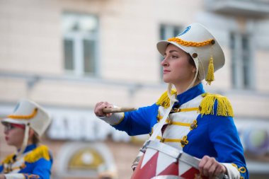 Belarus, Gomel, September 16, 2017. Celebrating the city day.A drummer woman walks down the street with a drum. The drummer from the city orchestra clipart