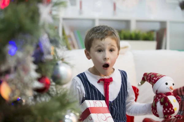 A boy with a Christmas gift.Get a gift for Christmas. The child received a gift