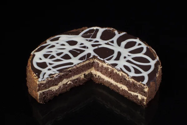 黒の背景に白のアイシングでチョコレート ケーキのスライス — ストック写真
