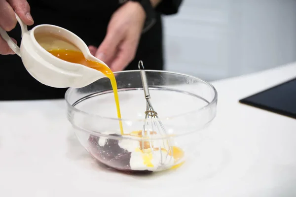 Cooking dessert. Pour the sauce into a glass bowl with a whisk