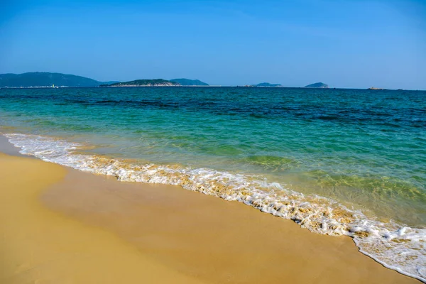 Güneşli bir gün, kum gıcırdıyor, turkuaz açık deniz, Güney Çin Denizi 'ndeki Yalong Körfezi kıyısındaki mercan resifleri. Sanya, Hainan Adası, Çin. Doğa Manzarası.