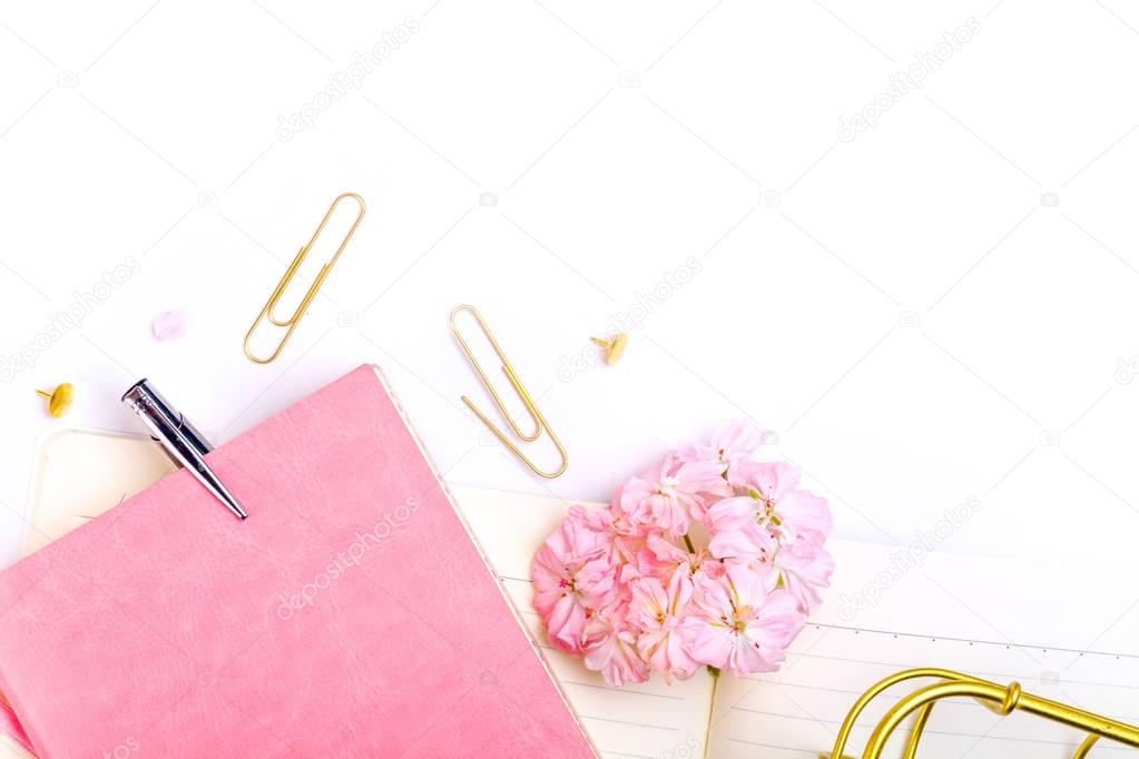 notebook, pen and pink flowers