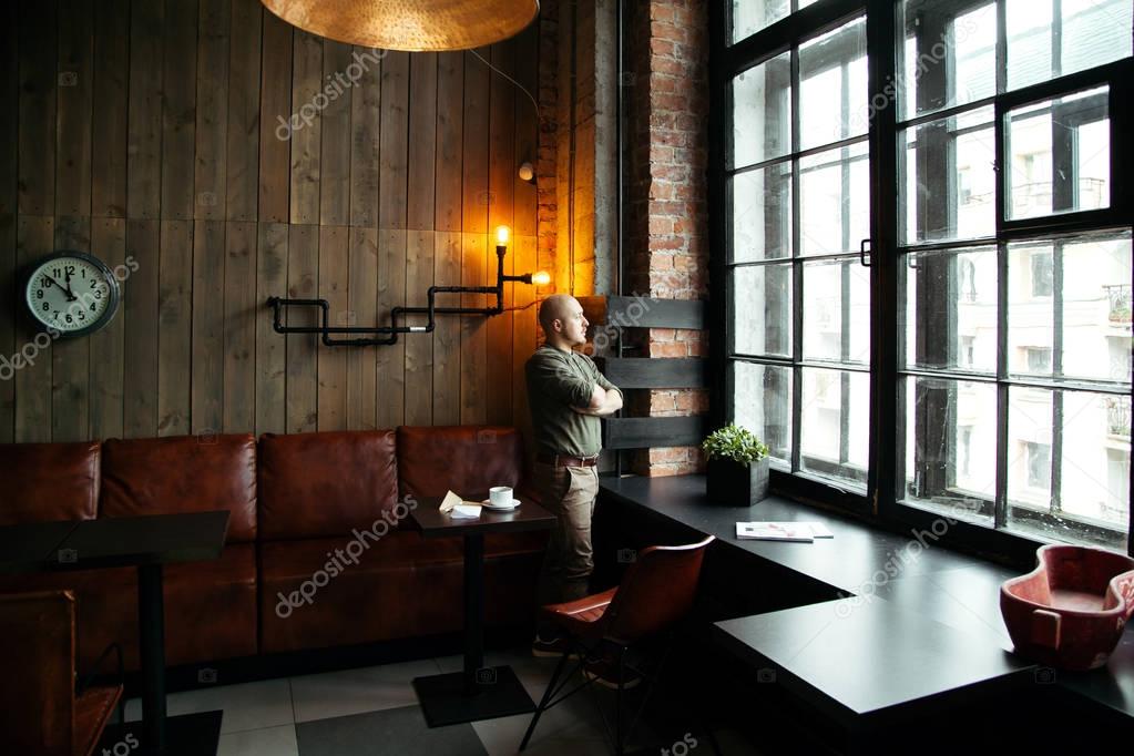 Fashionable man in loft-styled cafe