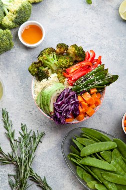 Kuskus, brokoli ve havuç pişmiş ile öğle yemeği için lezzetli sağlıklı kase küpleri, kızarmış bezelye, avokado ve kırmızı lahana kesmek. Kolay vejetaryen diyet kavramı. Rustik arka plan. Üstten Görünüm.