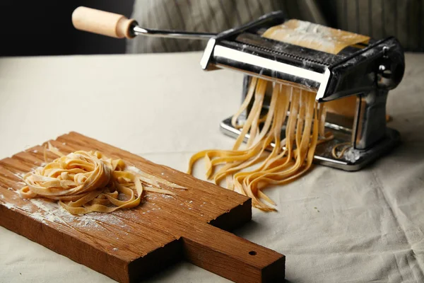 italian tagliatelle pasta made by hand using pasta maker