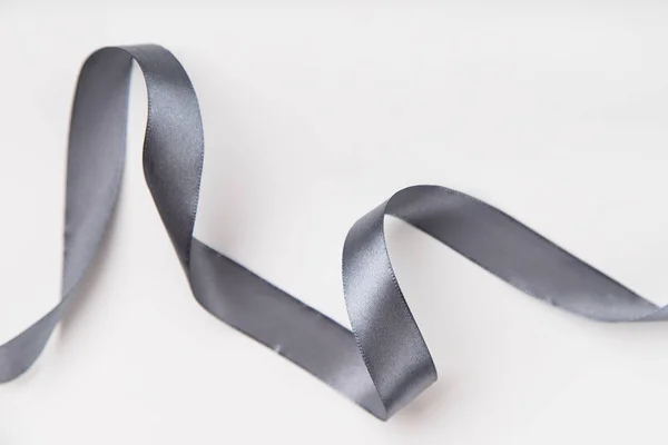 Curled Gray Silk Ribbon White Background Copy Space — Stock Photo, Image