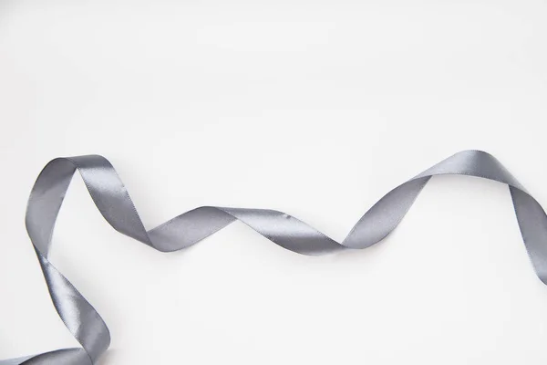 Curled Gray Silk Ribbon White Background Copy Space — Stock Photo, Image